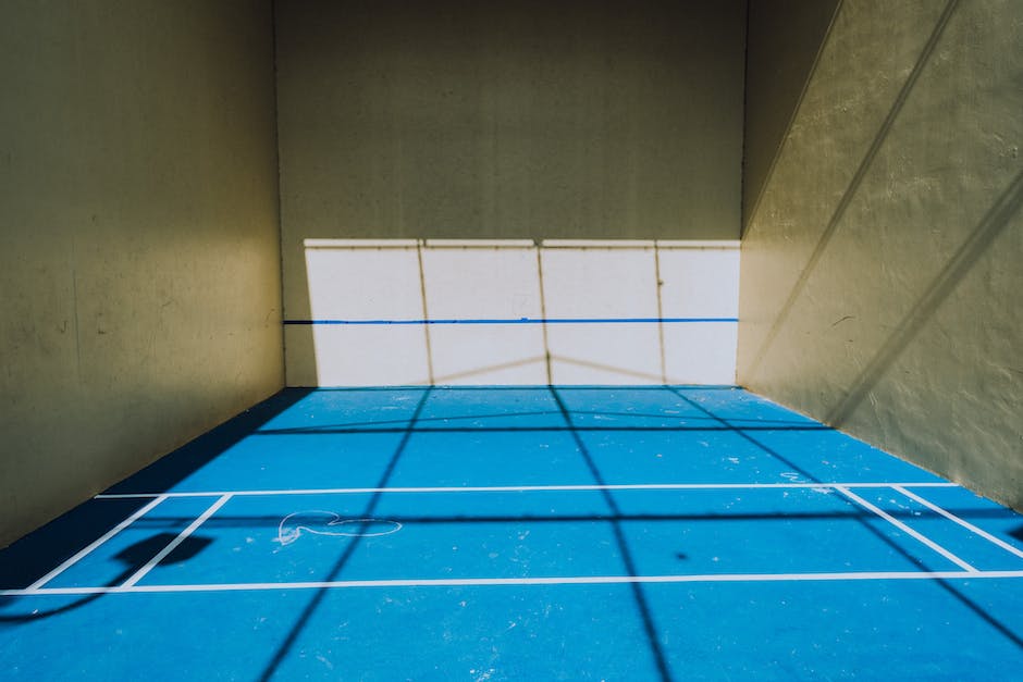 An image of a pickleball court with players engaged in a match, showcasing the sport of pickleball.
