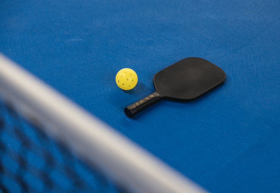 A close-up image of a pickleball paddle showing signs of delamination.